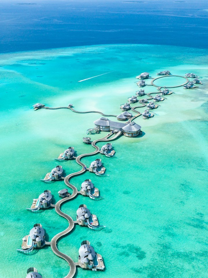 Overwater villas on a turquoise Maldives lagoon