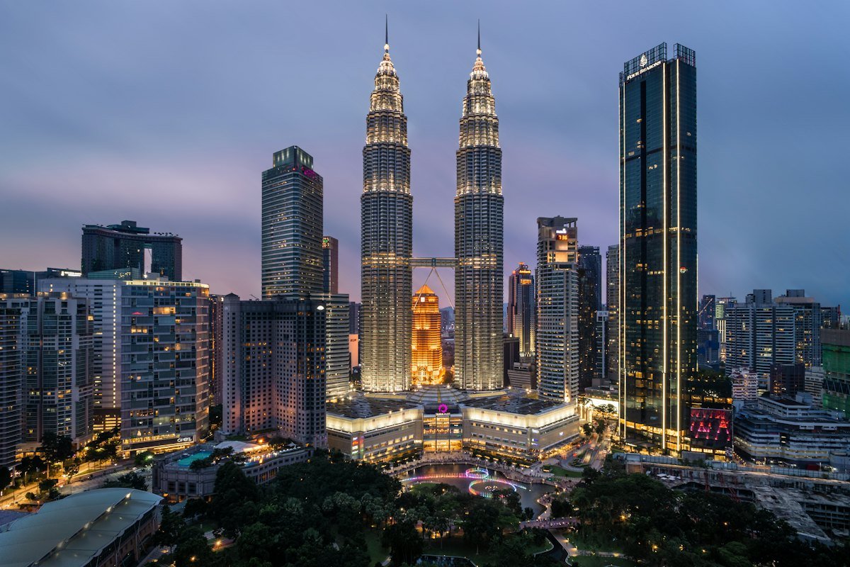 Kuala Lumpur skyline at dusk with the illuminated Petronas Towers